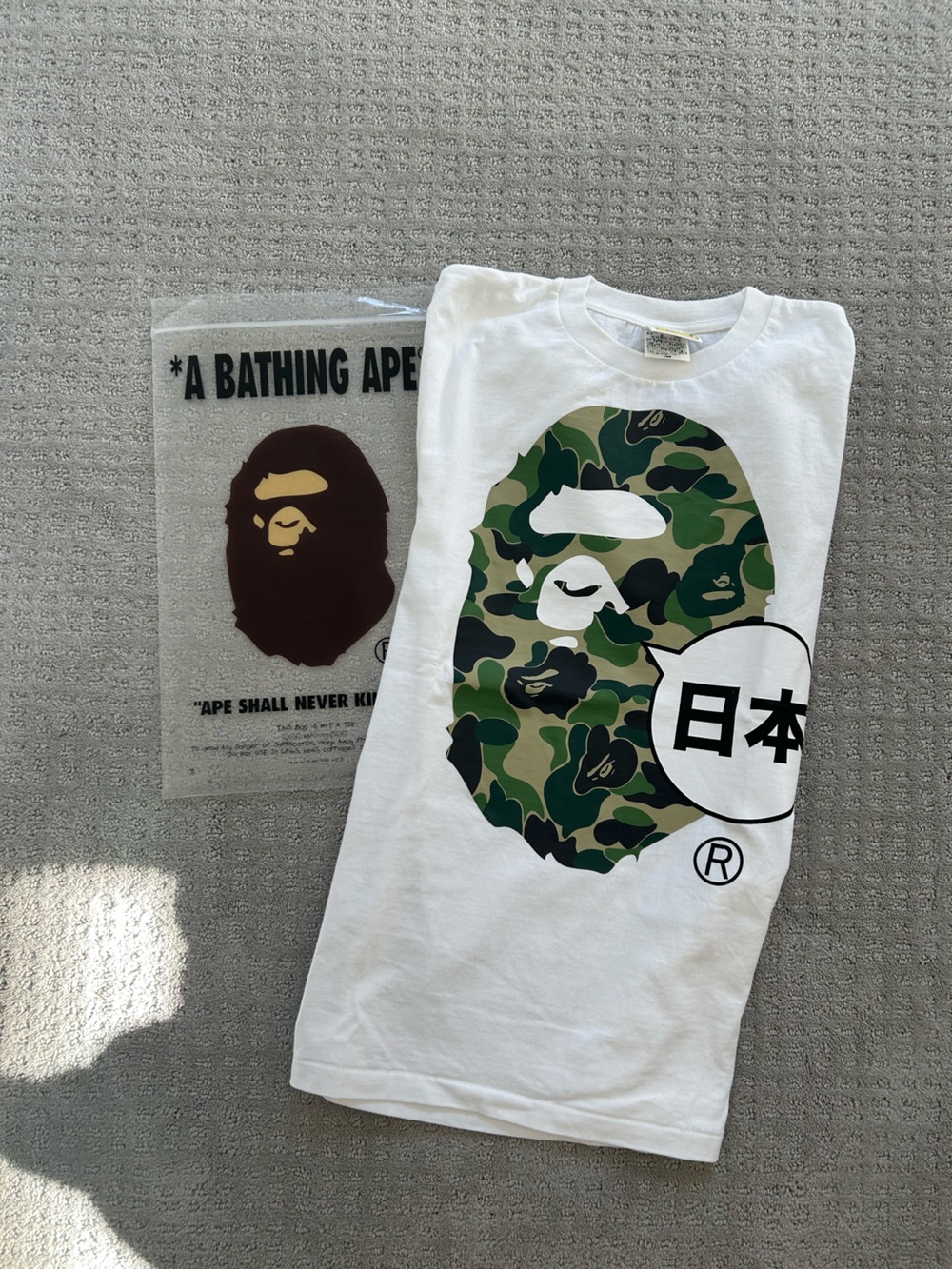 A Bathing Ape “Japan” White Short-Sleeve Tee with Green Camo Ape Logo